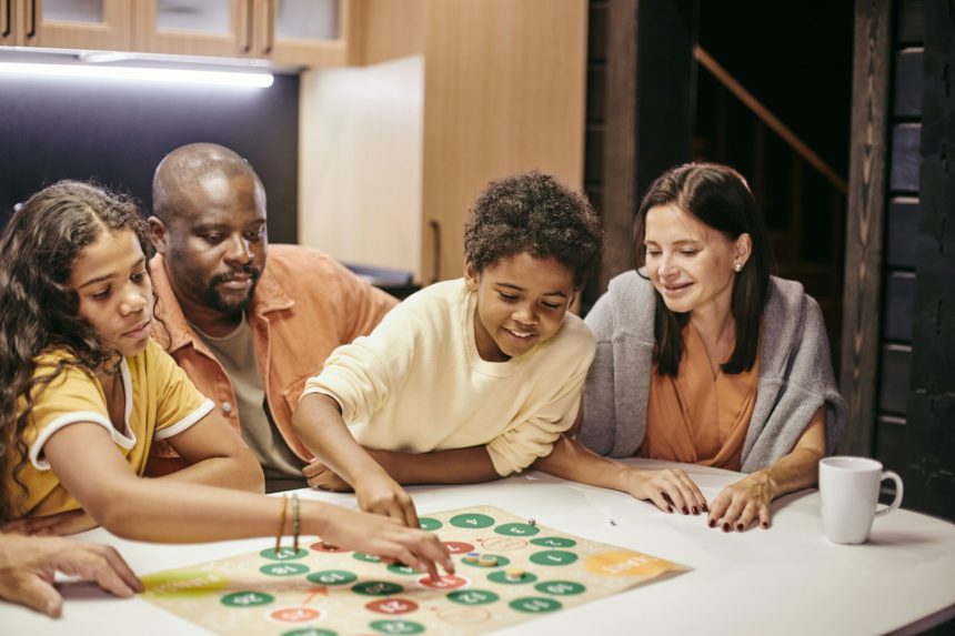 Family playing board game together