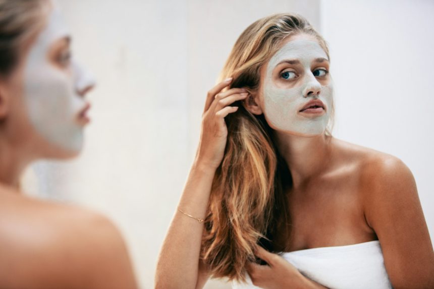 Female with facial cosmetic mask