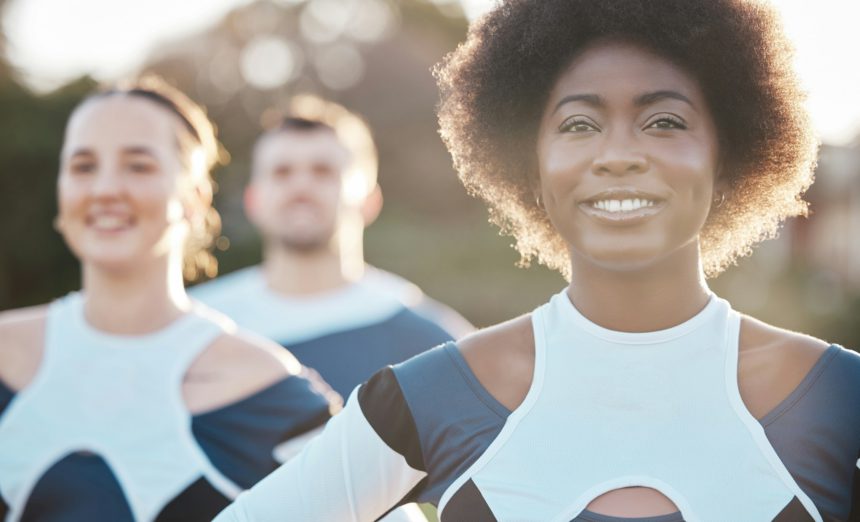 Smile, fitness and a cheerleader group outdoor together for support, motivation or competition in s